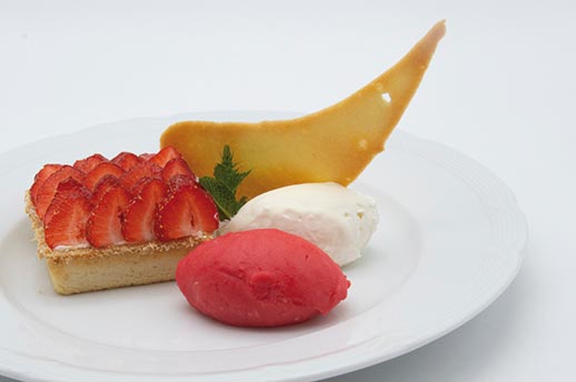 A luxury strawberry tart with sorbet and tuile